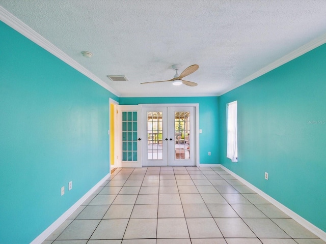 spare room with crown molding, a textured ceiling, visible vents, and french doors