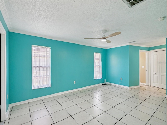 spare room featuring ornamental molding, ceiling fan, and a textured ceiling