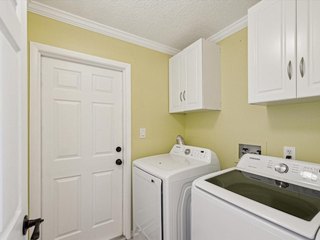 laundry area with washer and dryer, cabinet space, ornamental molding, and a textured ceiling