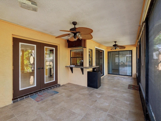 unfurnished sunroom with a healthy amount of sunlight and french doors