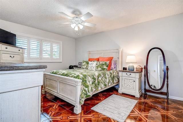 bedroom with a textured ceiling, baseboards, and ceiling fan