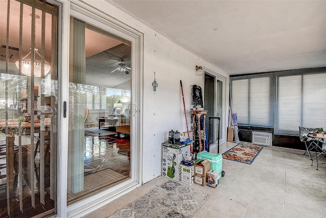 sunroom / solarium featuring ceiling fan and tile patterned floors