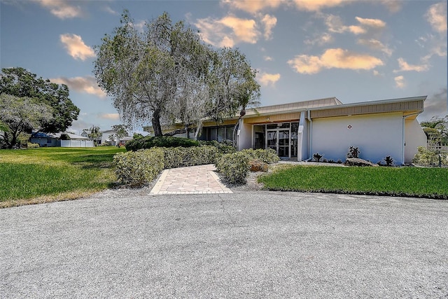 view of front of property featuring a front yard and stucco siding