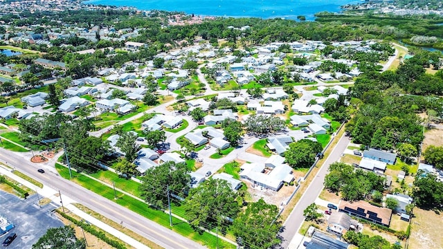 view of property location with a nearby body of water and nearby suburban area