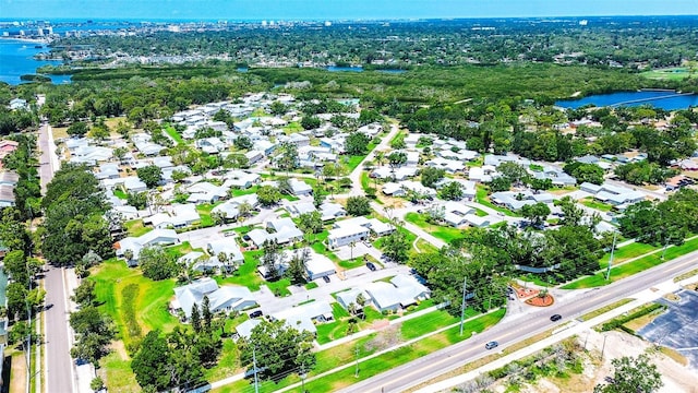 aerial overview of property's location featuring a nearby body of water and nearby suburban area