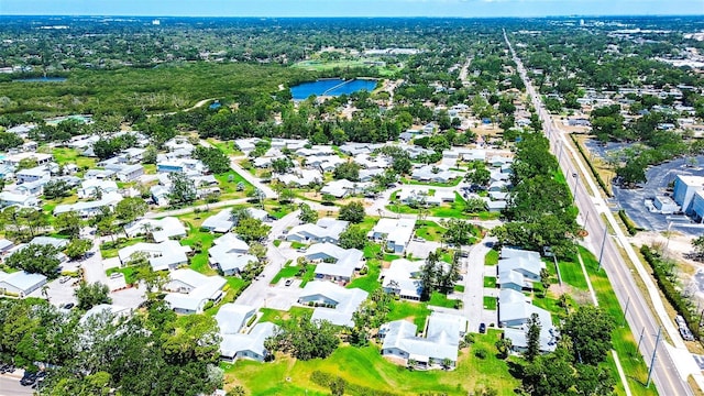view of property location featuring a nearby body of water and nearby suburban area