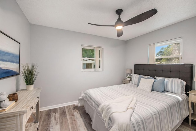 bedroom featuring baseboards, a ceiling fan, and wood finished floors
