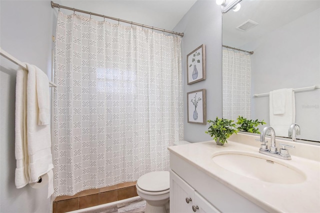 bathroom featuring toilet, visible vents, curtained shower, and vanity