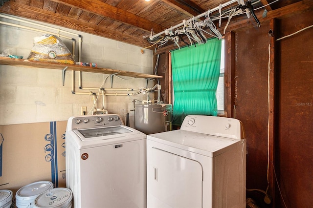 washroom featuring wood ceiling, electric water heater, washing machine and clothes dryer, laundry area, and concrete block wall