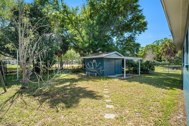 view of yard with an outbuilding, a fenced backyard, and a storage unit