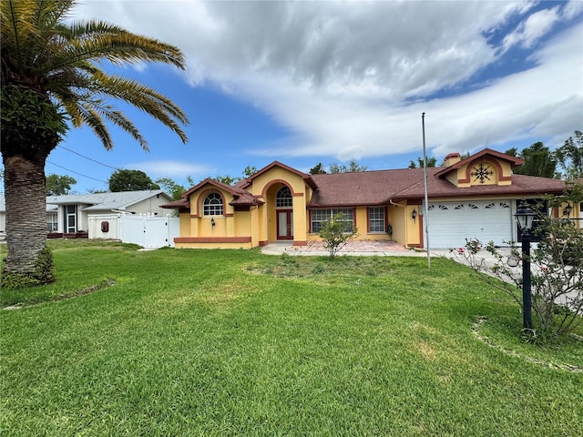 ranch-style house featuring an attached garage, stucco siding, fence, and a front yard