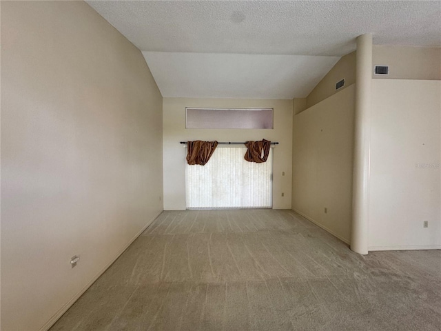 unfurnished room featuring lofted ceiling, baseboards, visible vents, and carpet floors