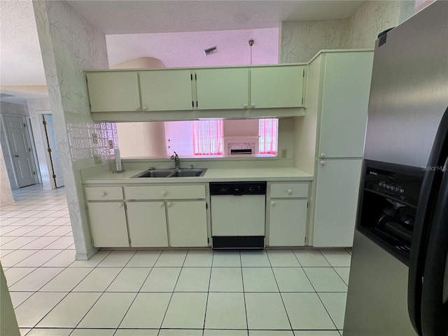 kitchen featuring a sink, visible vents, stainless steel fridge, light countertops, and white dishwasher