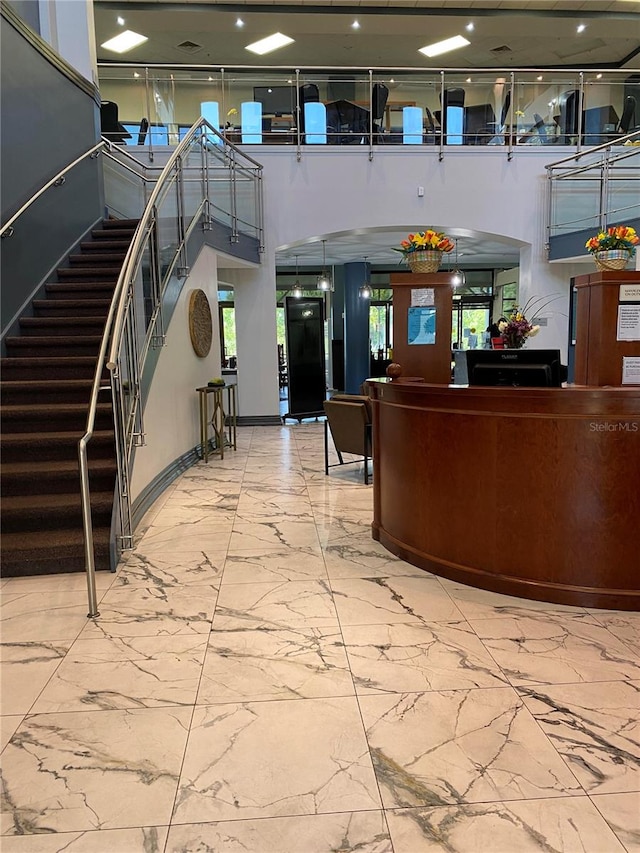 2115 N Halcyon Dr Unit 510, Sun City Center, FL 33573 - welcome area featuring stairs, arched walkways, and a high ceiling
