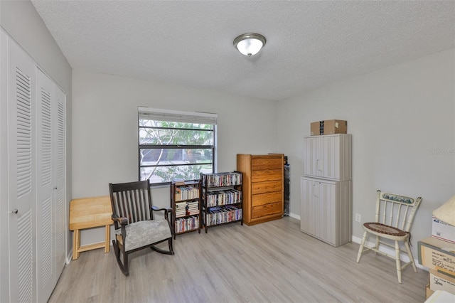 2115 N Halcyon Dr Unit 510, Sun City Center, FL 33573 - sitting room with light wood finished floors, a textured ceiling, and baseboards