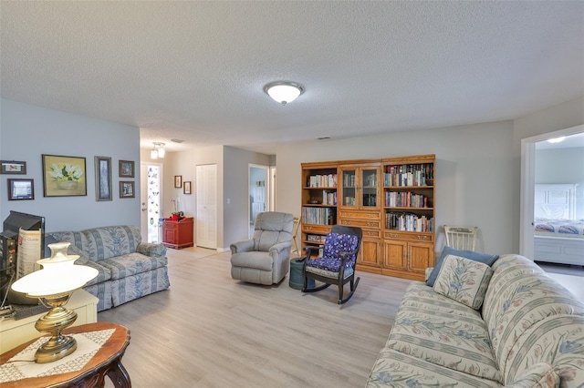 2115 N Halcyon Dr Unit 510, Sun City Center, FL 33573 - living area featuring light wood-style flooring and a textured ceiling