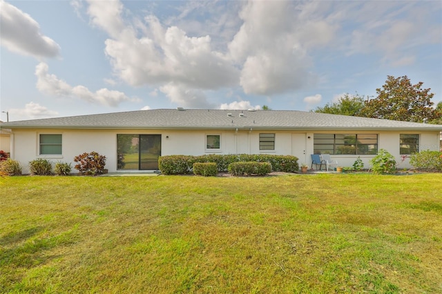 2115 N Halcyon Dr Unit 510, Sun City Center, FL 33573 - rear view of house with a lawn and stucco siding