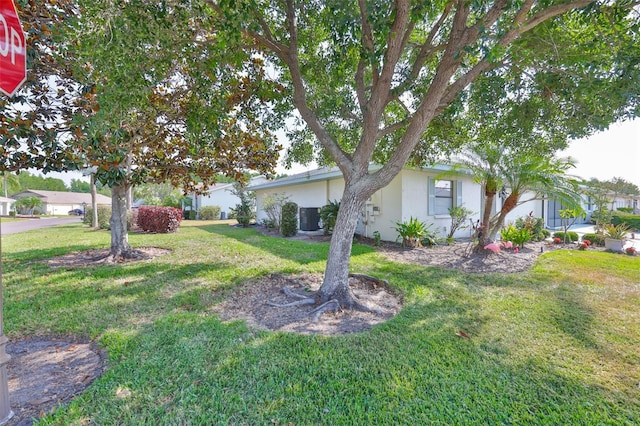 2115 N Halcyon Dr Unit 510, Sun City Center, FL 33573 - view of green lawn featuring central air condition unit