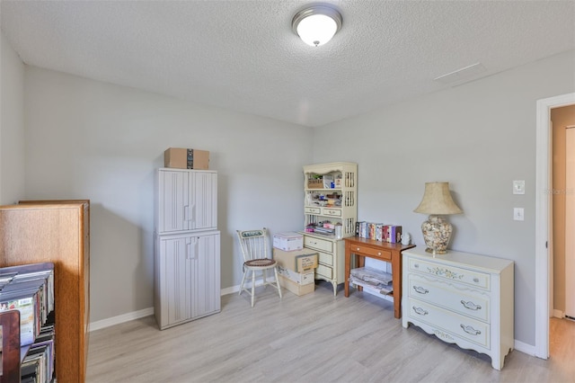 2115 N Halcyon Dr Unit 510, Sun City Center, FL 33573 - office space with light wood-style flooring, baseboards, and a textured ceiling