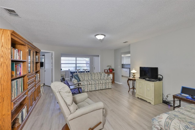 2115 N Halcyon Dr Unit 510, Sun City Center, FL 33573 - living room featuring light wood-style floors and a textured ceiling