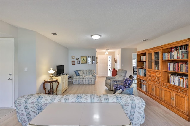 2115 N Halcyon Dr Unit 510, Sun City Center, FL 33573 - living room featuring light wood-type flooring and a textured ceiling