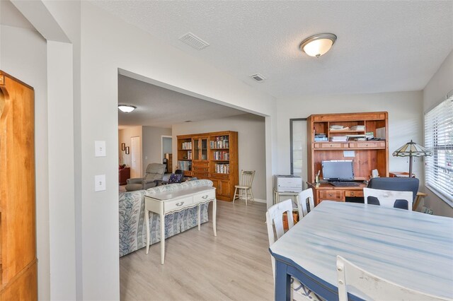 2115 N Halcyon Dr Unit 510, Sun City Center, FL 33573 - dining space with light wood finished floors, baseboards, and a textured ceiling
