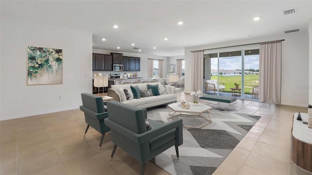 10652 Bridgegate Heights Loop, San Antonio, FL 33576 - living room with light tile patterned floors, recessed lighting, baseboards, and visible vents