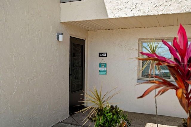 7701 Starkey Rd Unit 443, Seminole, FL 33777 - view of exterior entry featuring stucco siding