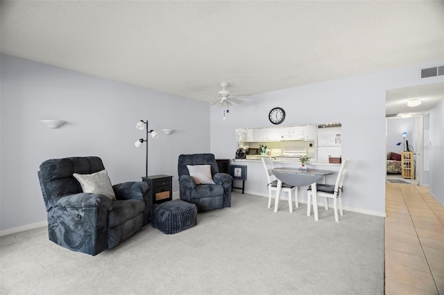 7701 Starkey Rd Unit 443, Seminole, FL 33777 - living room with a ceiling fan, baseboards, visible vents, and light colored carpet