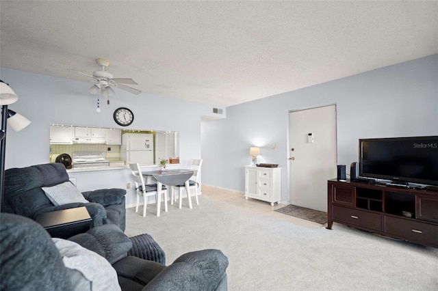 7701 Starkey Rd Unit 443, Seminole, FL 33777 - living room with light colored carpet, a textured ceiling, visible vents, and a ceiling fan