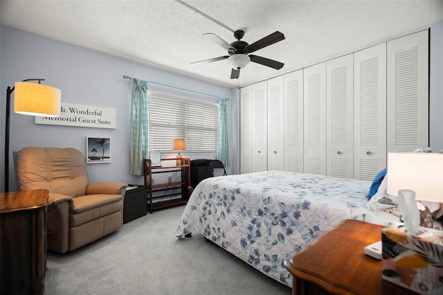 7701 Starkey Rd Unit 443, Seminole, FL 33777 - carpeted bedroom featuring a closet, a textured ceiling, and ceiling fan