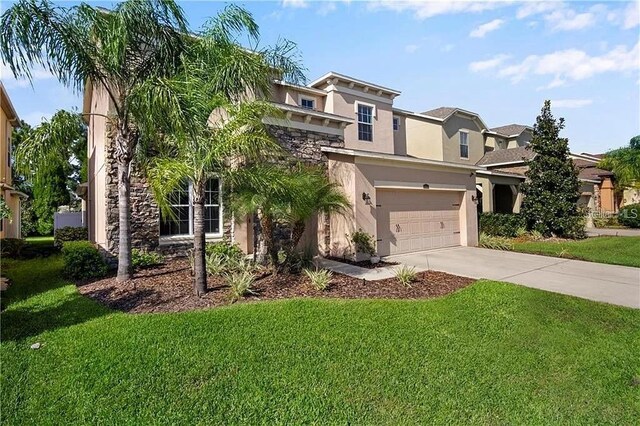 4407 Scarlet Loop, Wesley Chapel, FL 33544 - view of front facade featuring stucco siding, stone siding, driveway, a front yard, and a garage