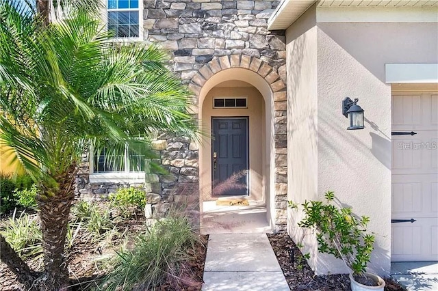 4407 Scarlet Loop, Wesley Chapel, FL 33544 - view of exterior entry featuring stone siding