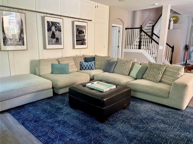 4407 Scarlet Loop, Wesley Chapel, FL 33544 - living area with wood finished floors, stairway, a textured ceiling, and arched walkways