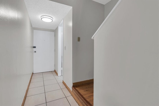 7505 Pitch Pine Cir Unit 122, Tampa, FL 33617 - corridor with a textured ceiling, baseboards, and light tile patterned flooring