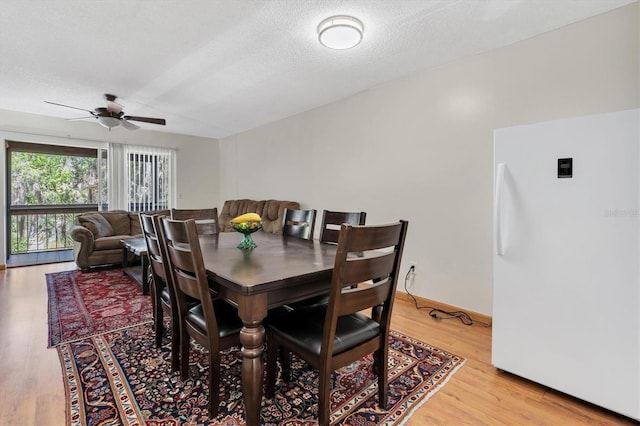 7505 Pitch Pine Cir Unit 122, Tampa, FL 33617 - dining area with a ceiling fan, a textured ceiling, and wood finished floors