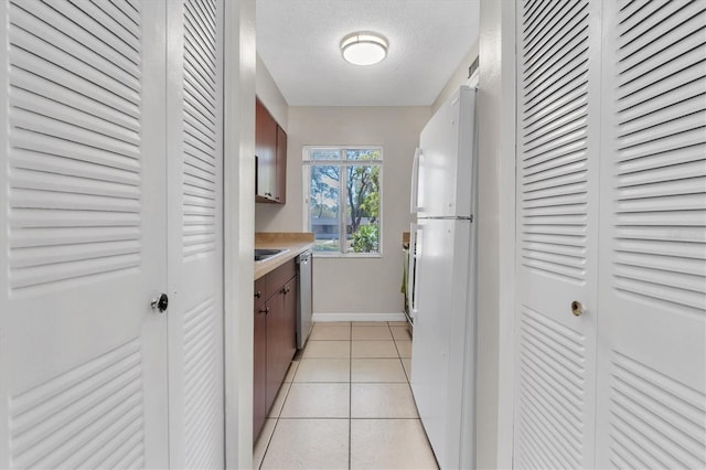 7505 Pitch Pine Cir Unit 122, Tampa, FL 33617 - interior space featuring a textured ceiling, baseboards, light tile patterned floors, and visible vents