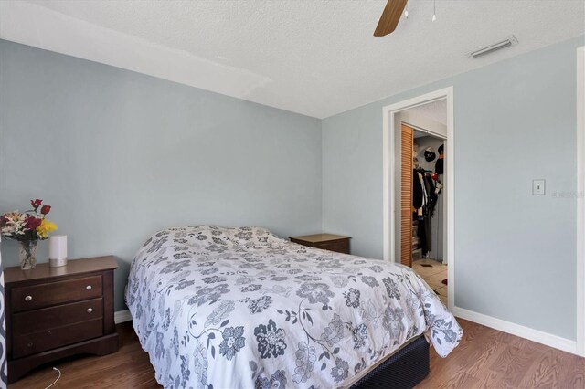 7505 Pitch Pine Cir Unit 122, Tampa, FL 33617 - bedroom featuring wood finished floors, a closet, visible vents, baseboards, and ceiling fan