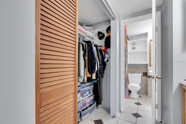 7505 Pitch Pine Cir Unit 122, Tampa, FL 33617 - walk in closet featuring light tile patterned floors