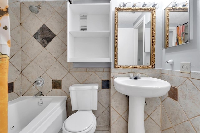 7505 Pitch Pine Cir Unit 122, Tampa, FL 33617 - bathroom with tile walls, shower / bath combo with shower curtain, and toilet