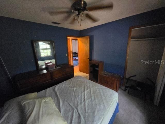 bedroom featuring carpet flooring, visible vents, and ceiling fan