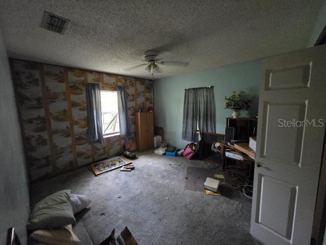 interior space with carpet, visible vents, and a textured ceiling
