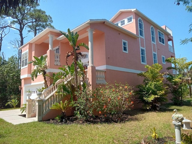 6926 Mccray Dr, Hudson, FL 34667 - view of property exterior with stucco siding and a lawn