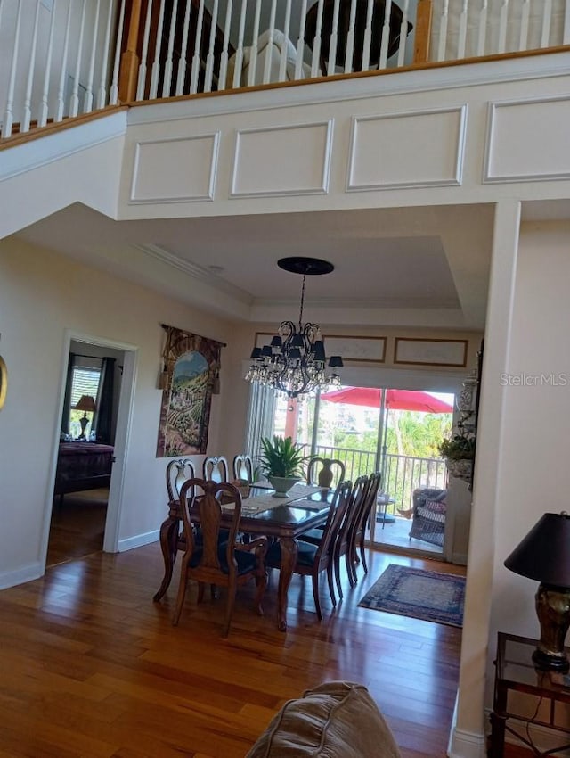 6926 Mccray Dr, Hudson, FL 34667 - dining space with wood finished floors, a chandelier, and baseboards