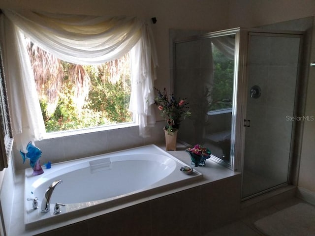6926 Mccray Dr, Hudson, FL 34667 - bathroom with a bath, a shower stall, and tile patterned flooring