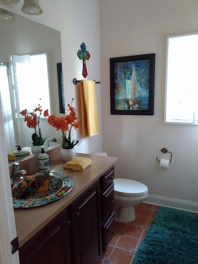 6926 Mccray Dr, Hudson, FL 34667 - full bathroom with vanity, toilet, and tile patterned flooring