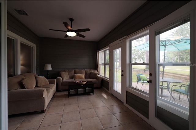 sunroom with tile patterned flooring, french doors, and visible vents