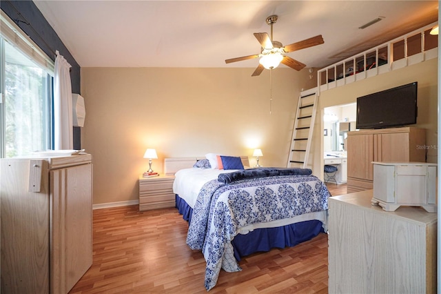 bedroom with ceiling fan, light wood-style flooring, baseboards, and visible vents