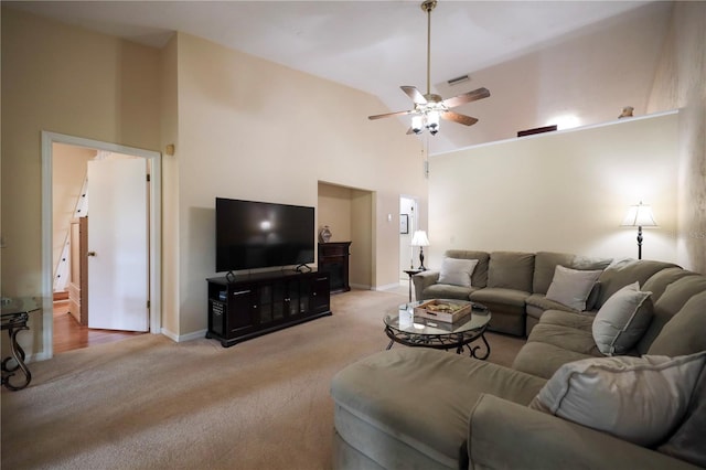 living room with a ceiling fan, light carpet, high vaulted ceiling, and baseboards