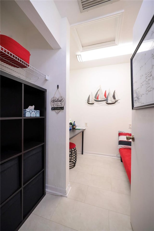 interior space featuring tile patterned flooring, attic access, and visible vents